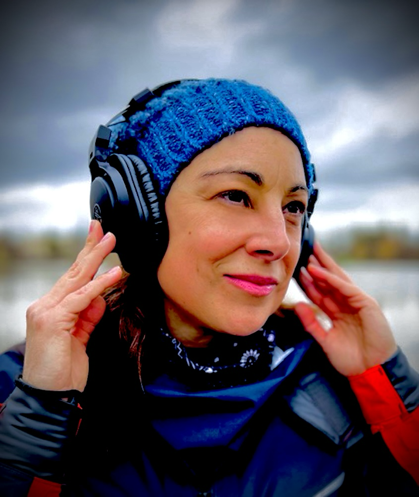 Estelle Transon en écoute, bonnet bleu et casque, bord de fleuve